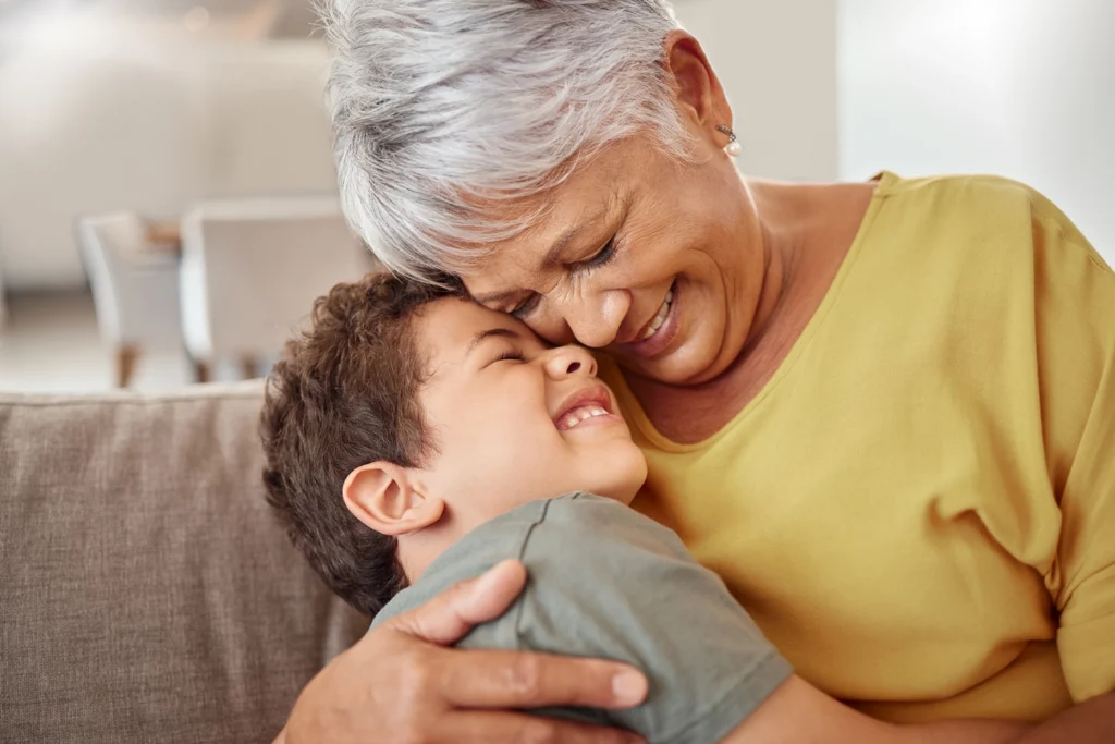 Country-Bank-grandmother-hugging-her-grandson-on-the-couch