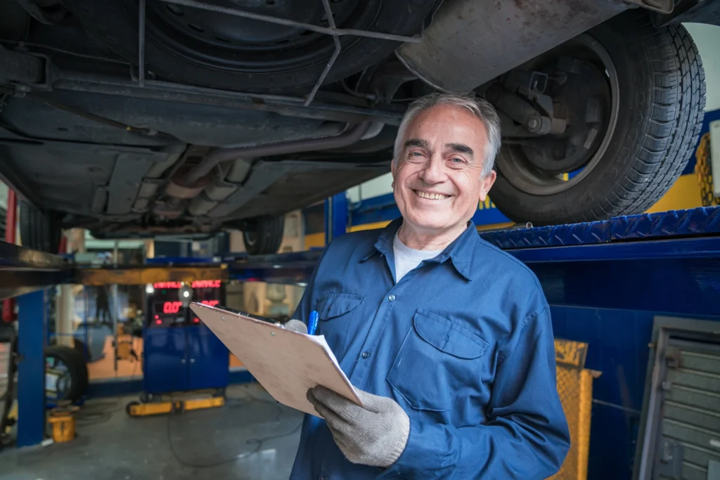 Country-Bank-mechanic-in-garage-holding-loan-papers-in-hand