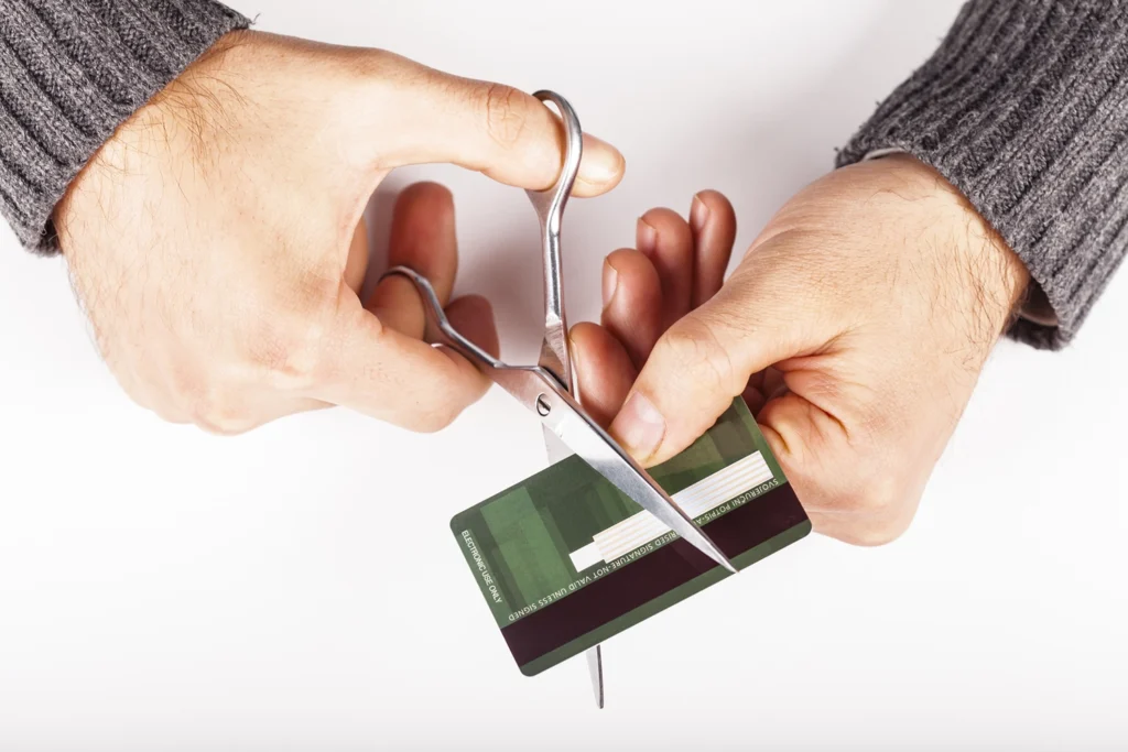 Country-Bank-person-cutting-their-card-in-half-with-a-pair-of-scissors