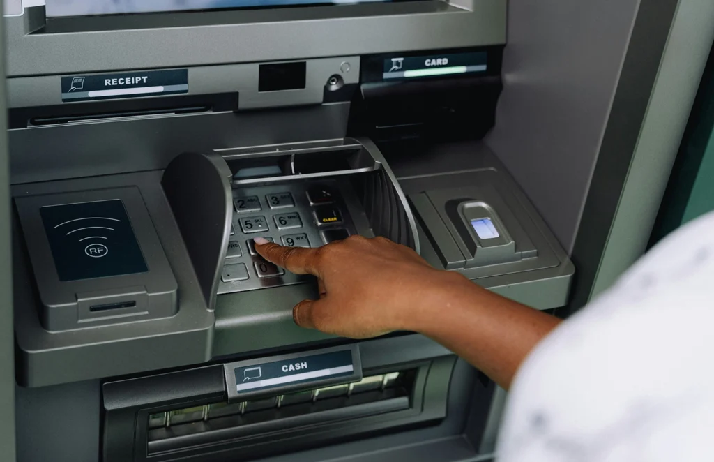 Country-Bank-person-using-ATM-machine