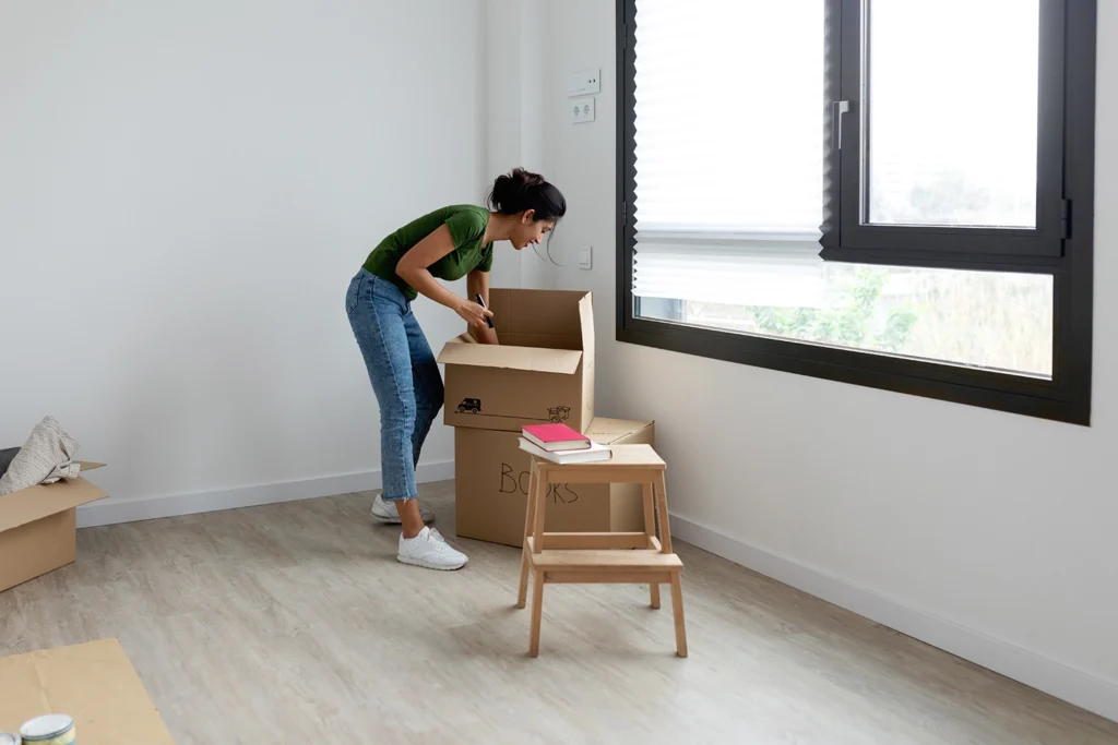 Country-Bank-young-woman-unpacking-a-box-of-books