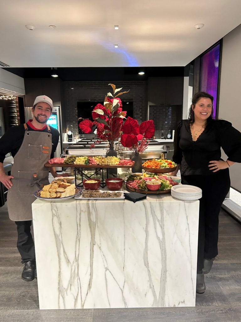 The owners of Charcut to go in a kitchen with their food