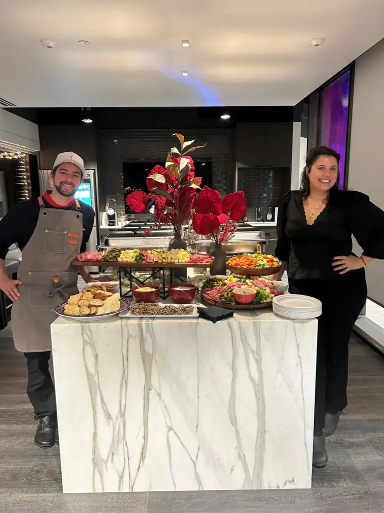 The owners of Charcut to go in a kitchen with their food