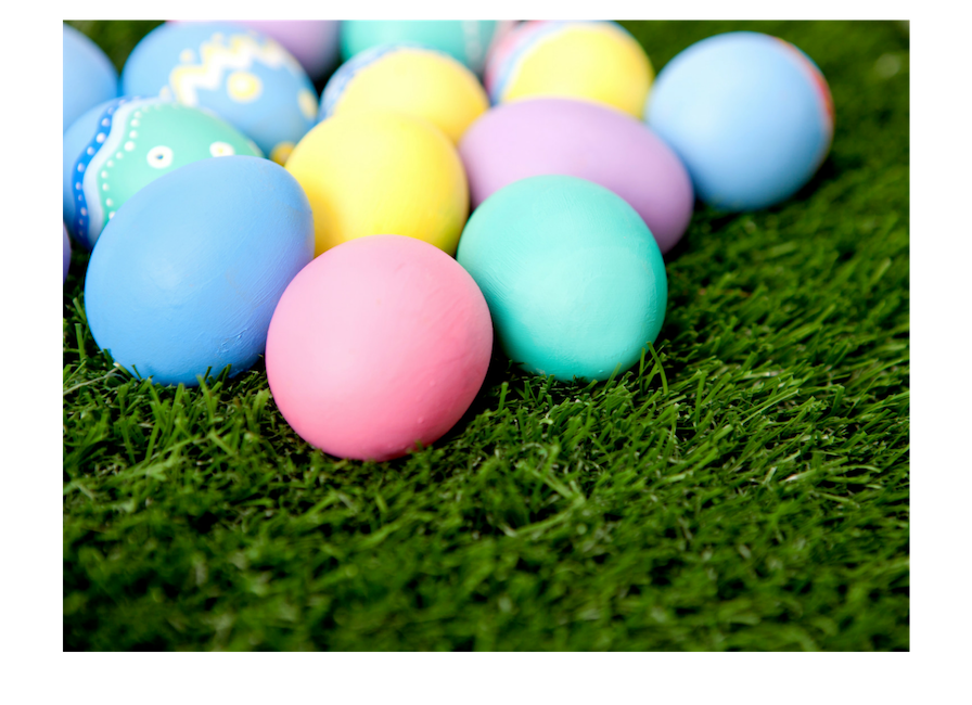 Colorful Easter eggs laying on grass.